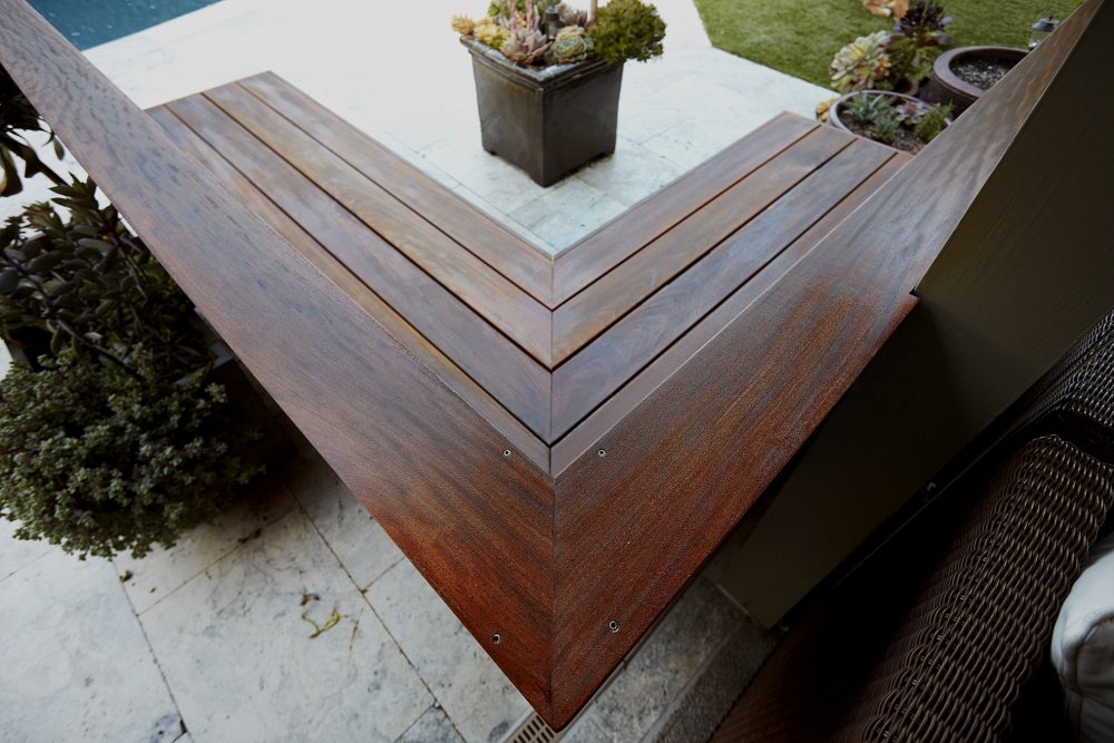 Exterior design top view of polished dark L shaped wooden built-in bench