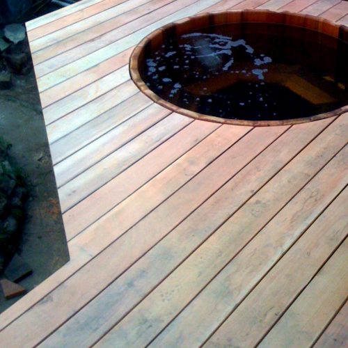 Sunken hot tub surrounded by wooden deck