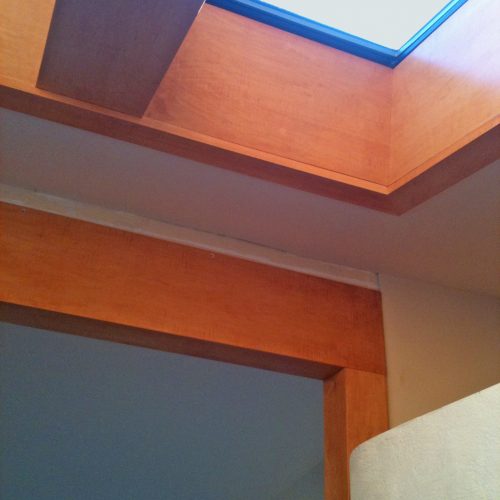 Wood beam and skylight above doorway