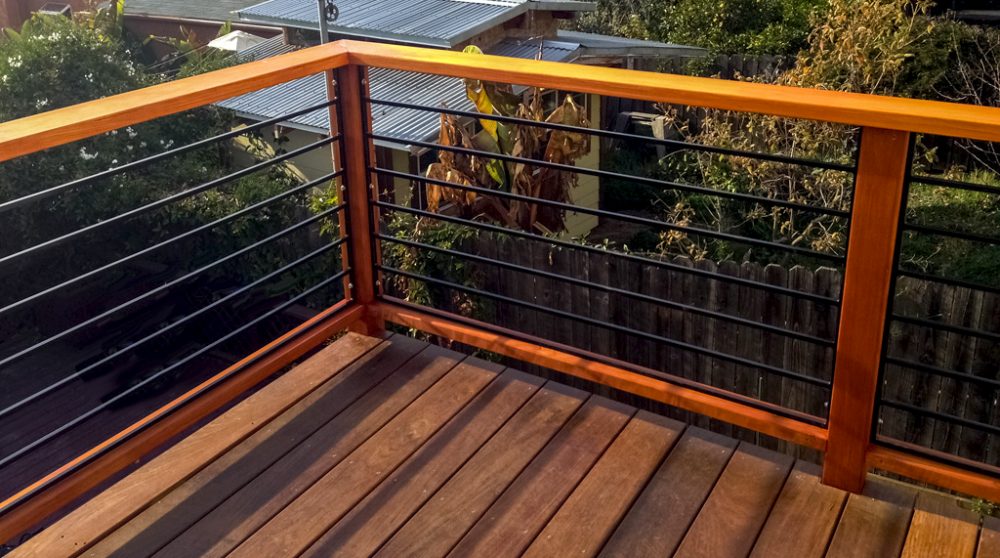 Second story wood deck with black cable railing